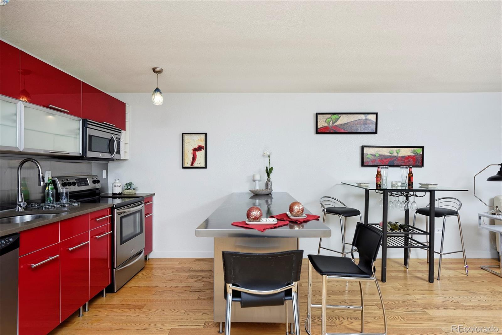 75 Emerson Street, Unit 103 Denver, CO 80218 - Photo 4 of 19 a kitchen with granite countertop a dining table chairs cabinets and stainless steel appliances