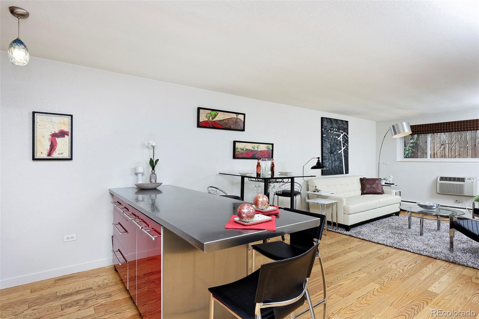 75 Emerson Street, Unit 103 Denver, CO 80218 - Photo 5 of 19 a living room with furniture and wooden floor