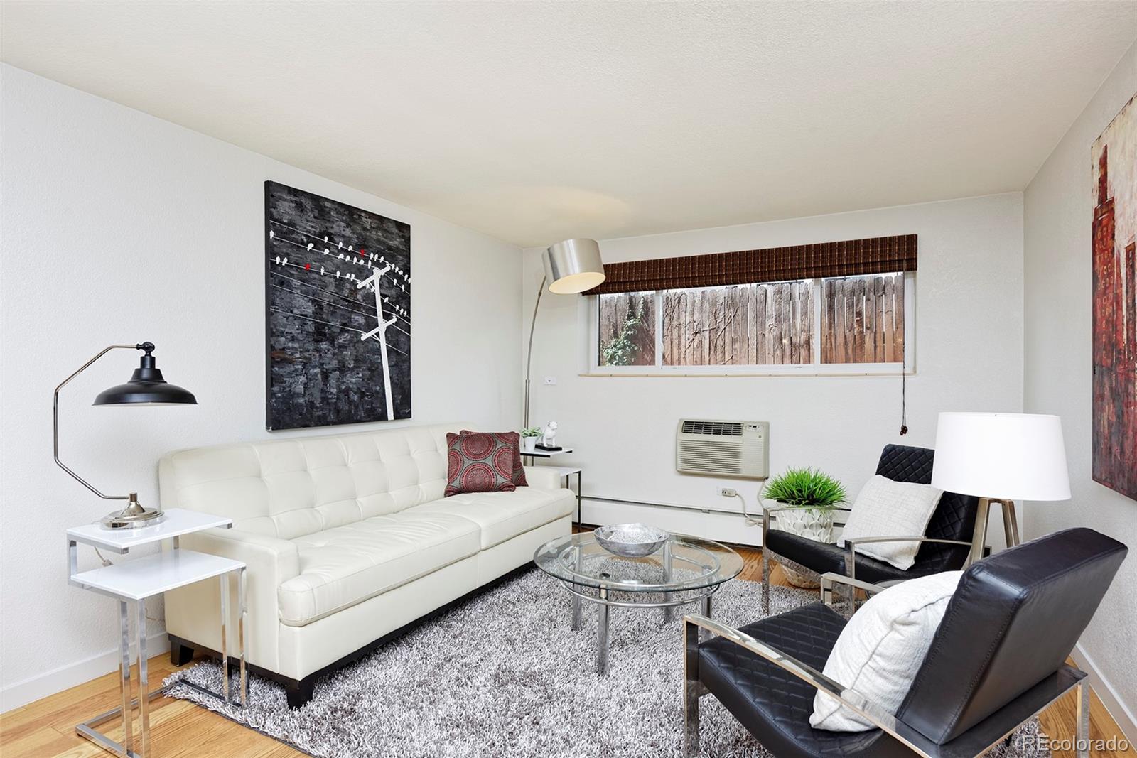 75 Emerson Street, Unit 103 Denver, CO 80218 - Photo 7 of 19 a living room with furniture and a window