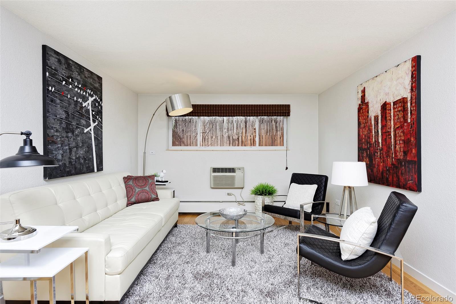 75 Emerson Street, Unit 103 Denver, CO 80218 - Photo 8 of 19 a living room with furniture a rug and a painting on the wall