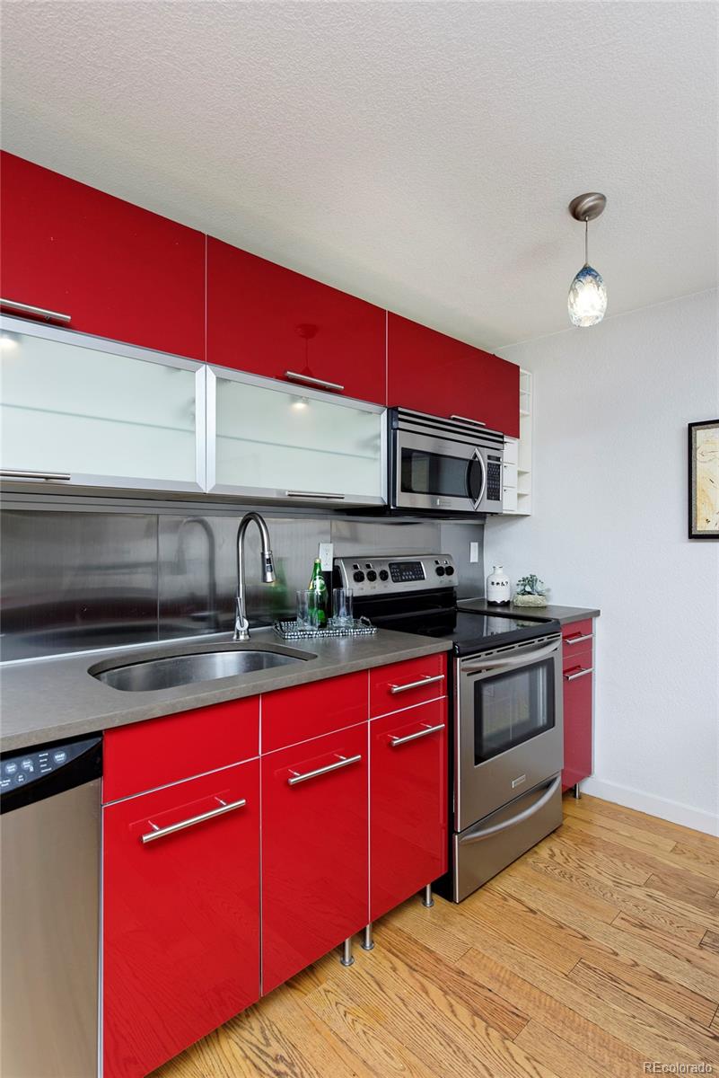 75 Emerson Street, Unit 103 Denver, CO 80218 - Photo 10 of 19 a kitchen with stainless steel appliances a sink dishwasher stove and oven with cabinets