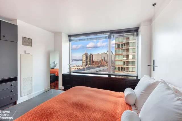 a living room with furniture and floor to ceiling window