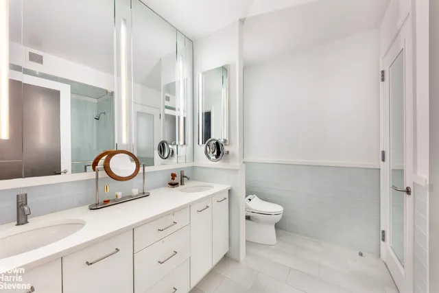 a bedroom with a bed and dresser with mirror