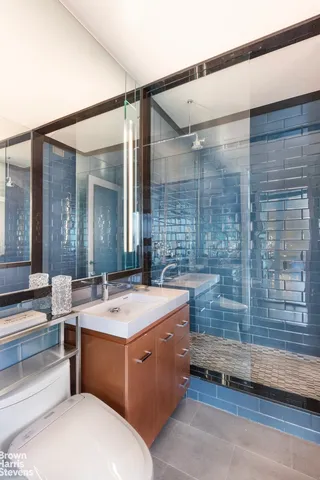 a bathroom with a double vanity sink mirror and toilet