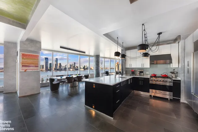 a white building with glass top table and chairs