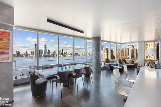 a kitchen with stainless steel appliances lots of counter top space and furniture