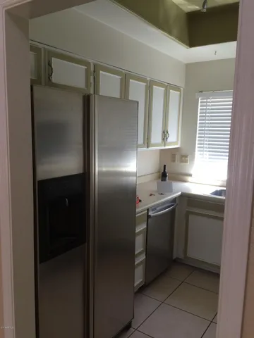 a kitchen with a sink and refrigerator