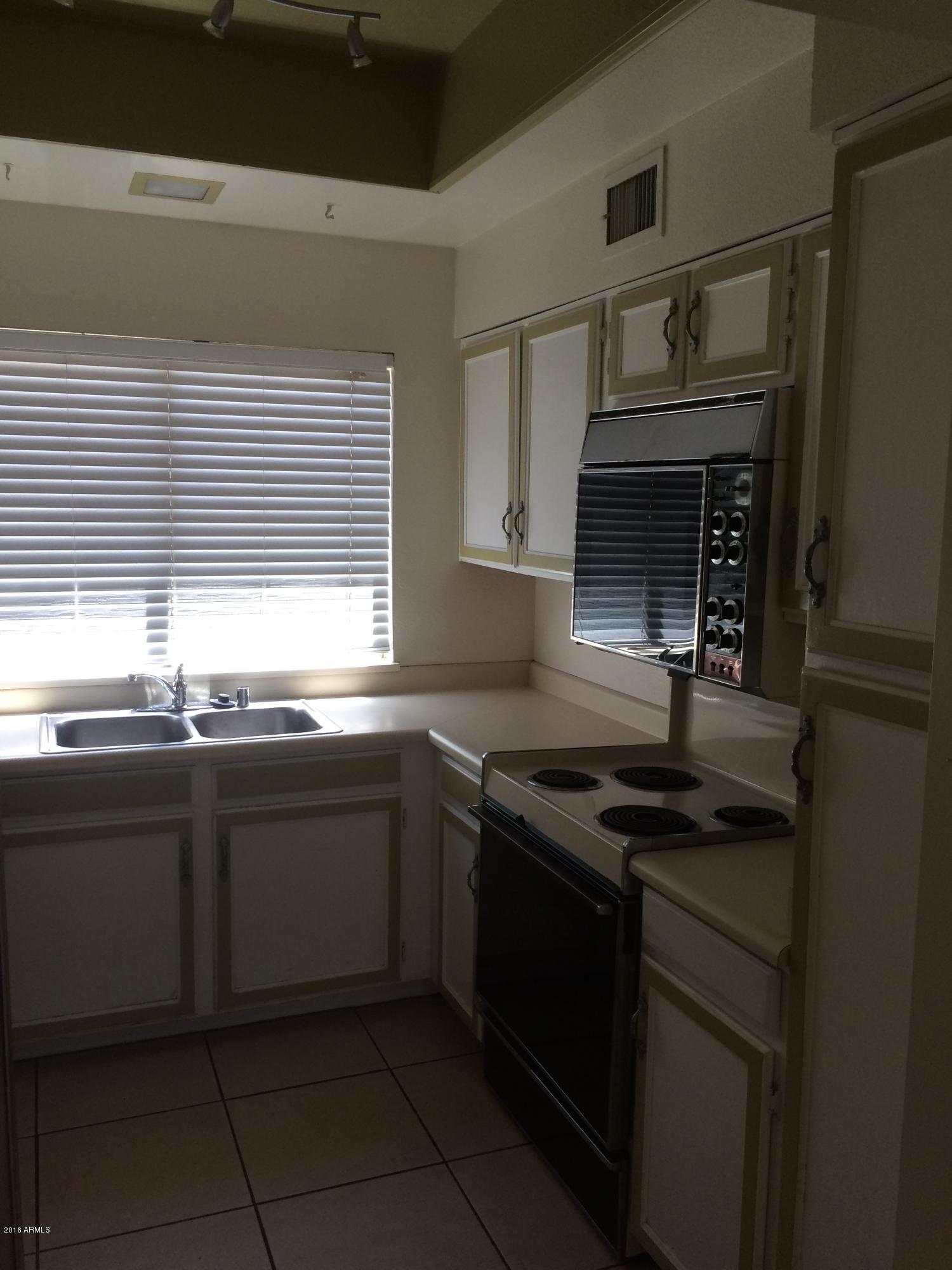 304 East Bluebell Lane Tempe, AZ 85288 - Photo 5 of 24 a kitchen with granite countertop a sink and cabinets