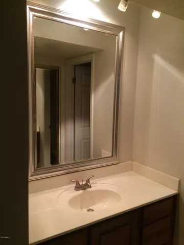 a bathroom with a sink vanity and a mirror