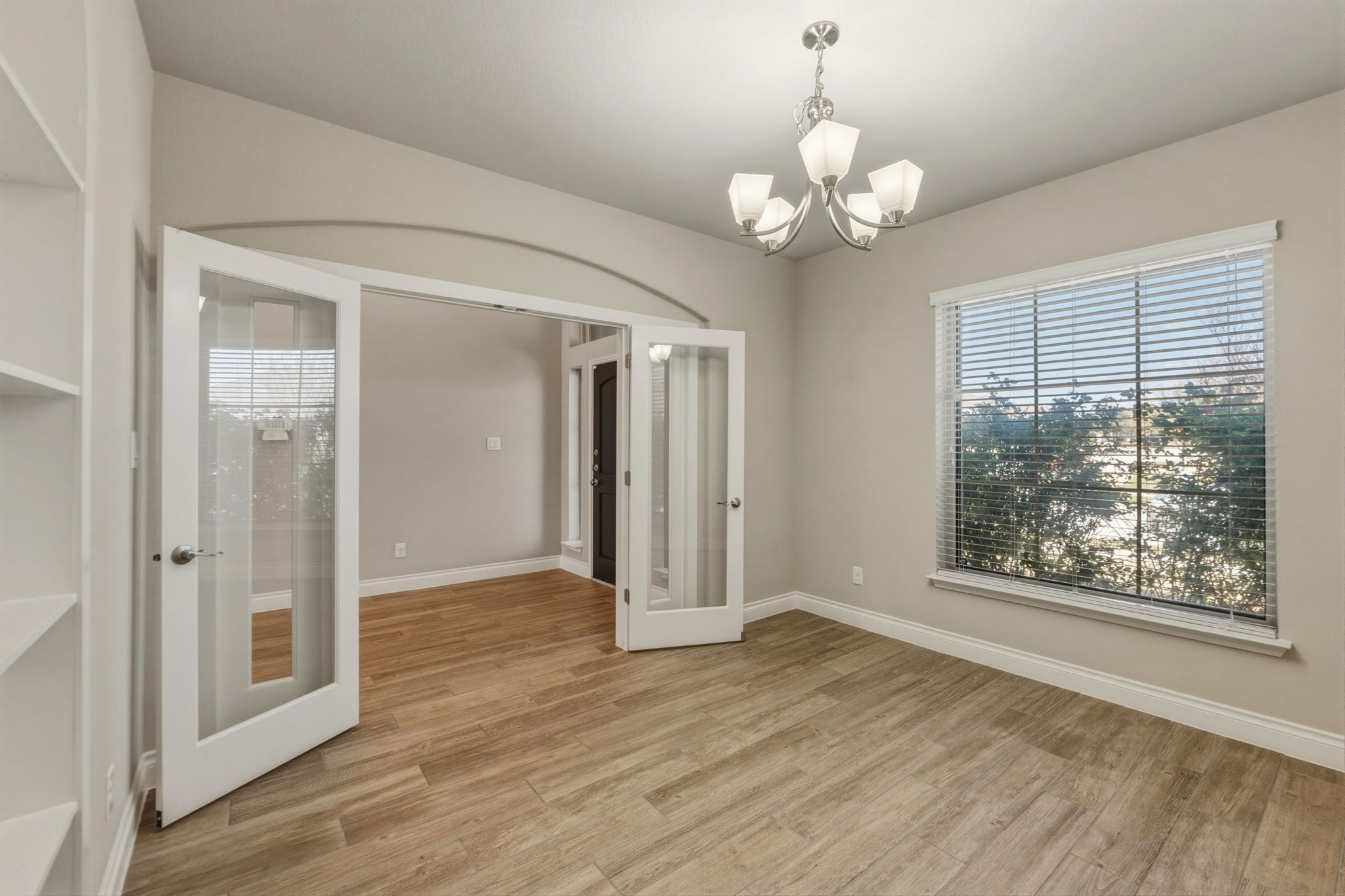 1320 Low Branch Lane Leander, TX 78641 - Photo 11 of 38 a view of an empty room with wooden floor and a window
