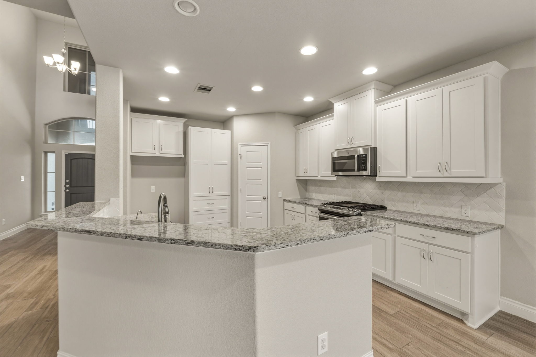 1320 Low Branch Lane Leander, TX 78641 - Photo 14 of 38 a kitchen with stainless steel appliances granite countertop a sink a stove and cabinets