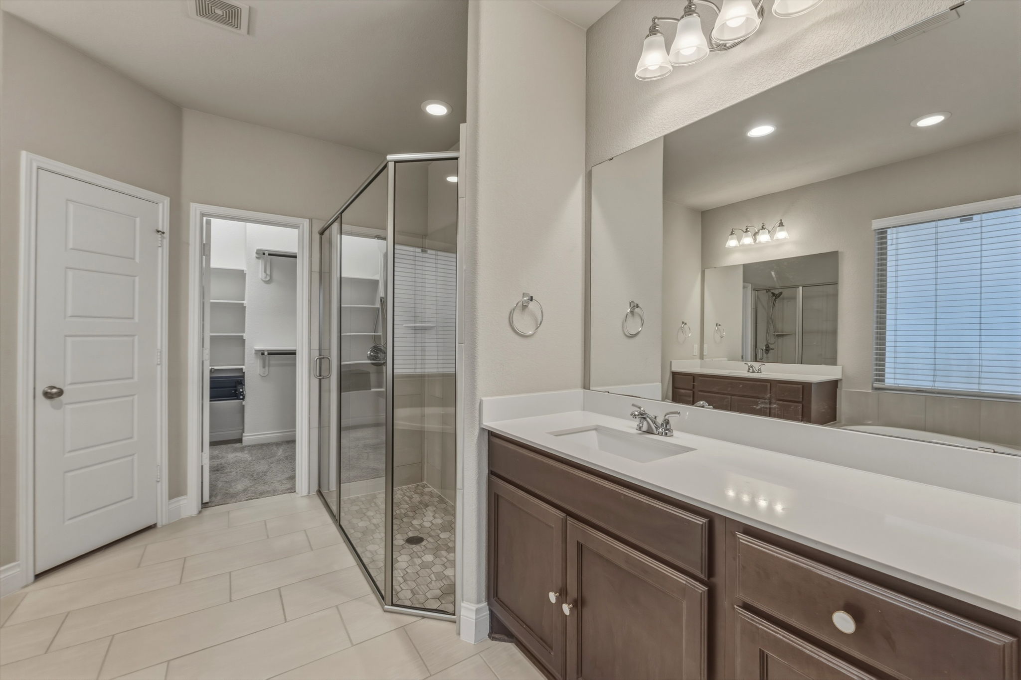 1320 Low Branch Lane Leander, TX 78641 - Photo 22 of 38 a spacious bathroom with a shower sink and mirror