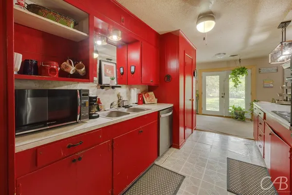 a kitchen with stainless steel appliances a stove and a microwave