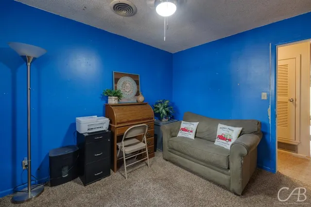 a living room with furniture and gym equipment