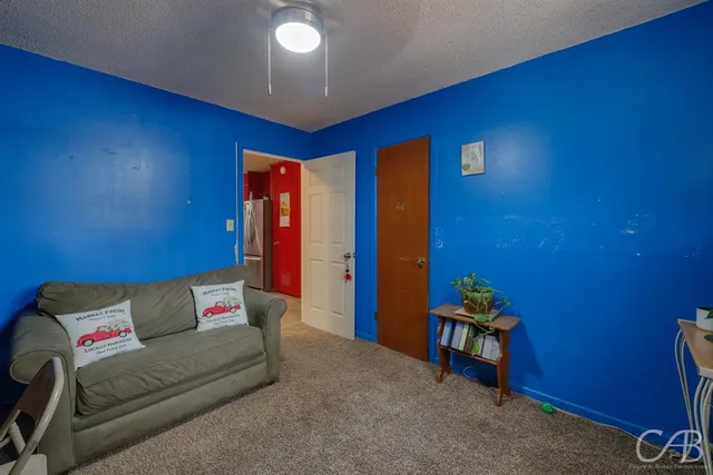 a bedroom with furniture and flat screen tv