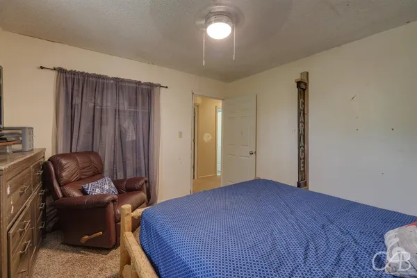 a bedroom with a bed and a television