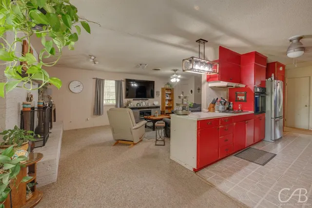a kitchen with stainless steel appliances granite countertop a sink and cabinets
