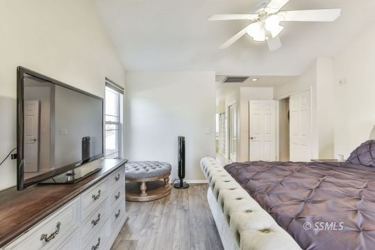 1214 North Guam Street Ridgecrest, CA 93555 - Photo 38 of 48 a spacious bedroom with a large bed and a chandelier
