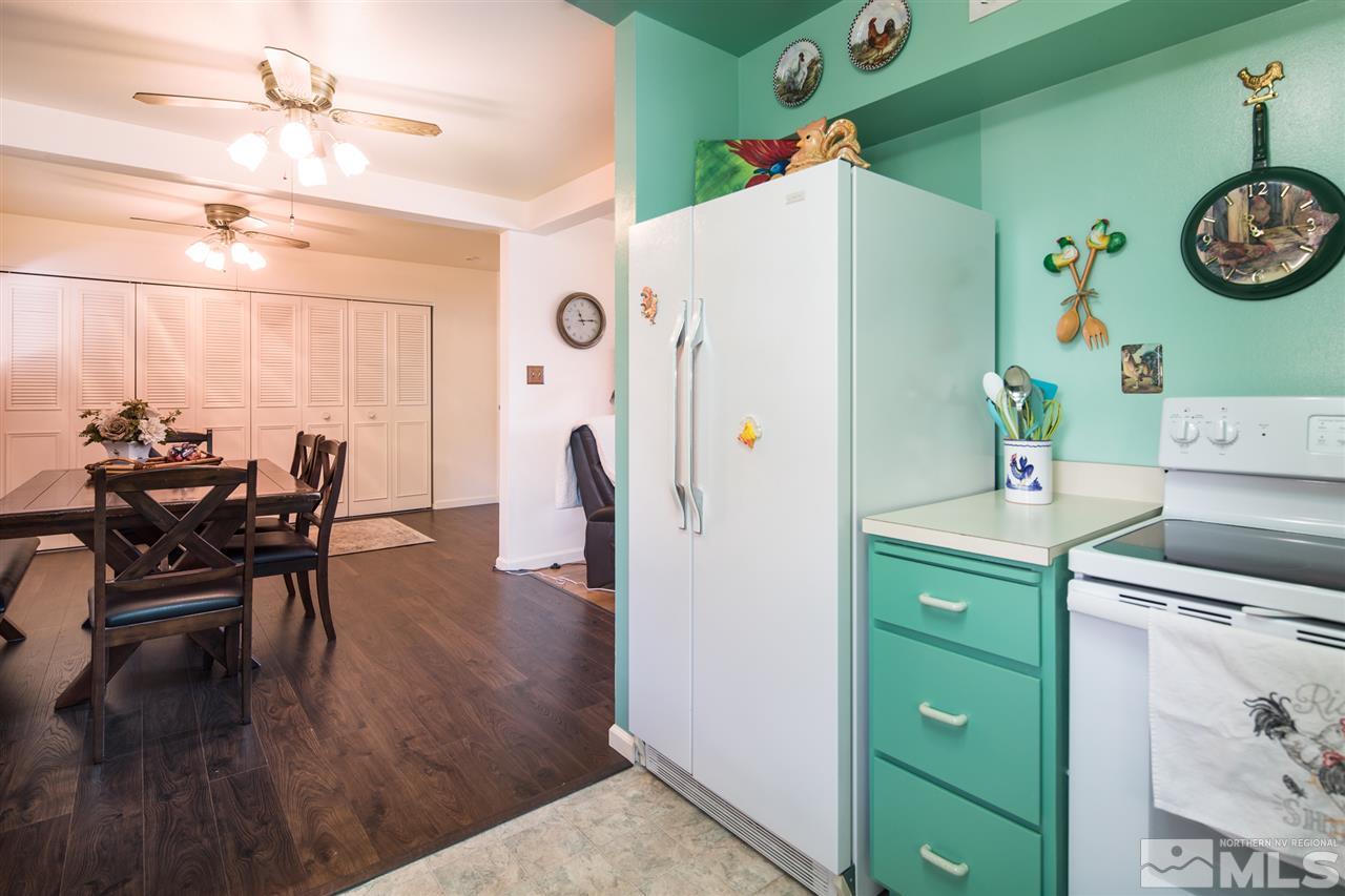 1665 Clemson Road Reno, NV 89502 - Photo 11 of 25 a kitchen with a refrigerator and a table in it