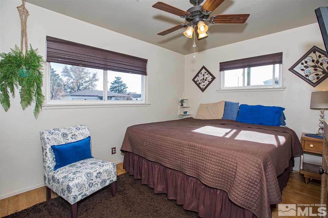 1665 Clemson Road Reno, NV 89502 - Photo 14 of 25 a bedroom with a bed and a window with the outer view