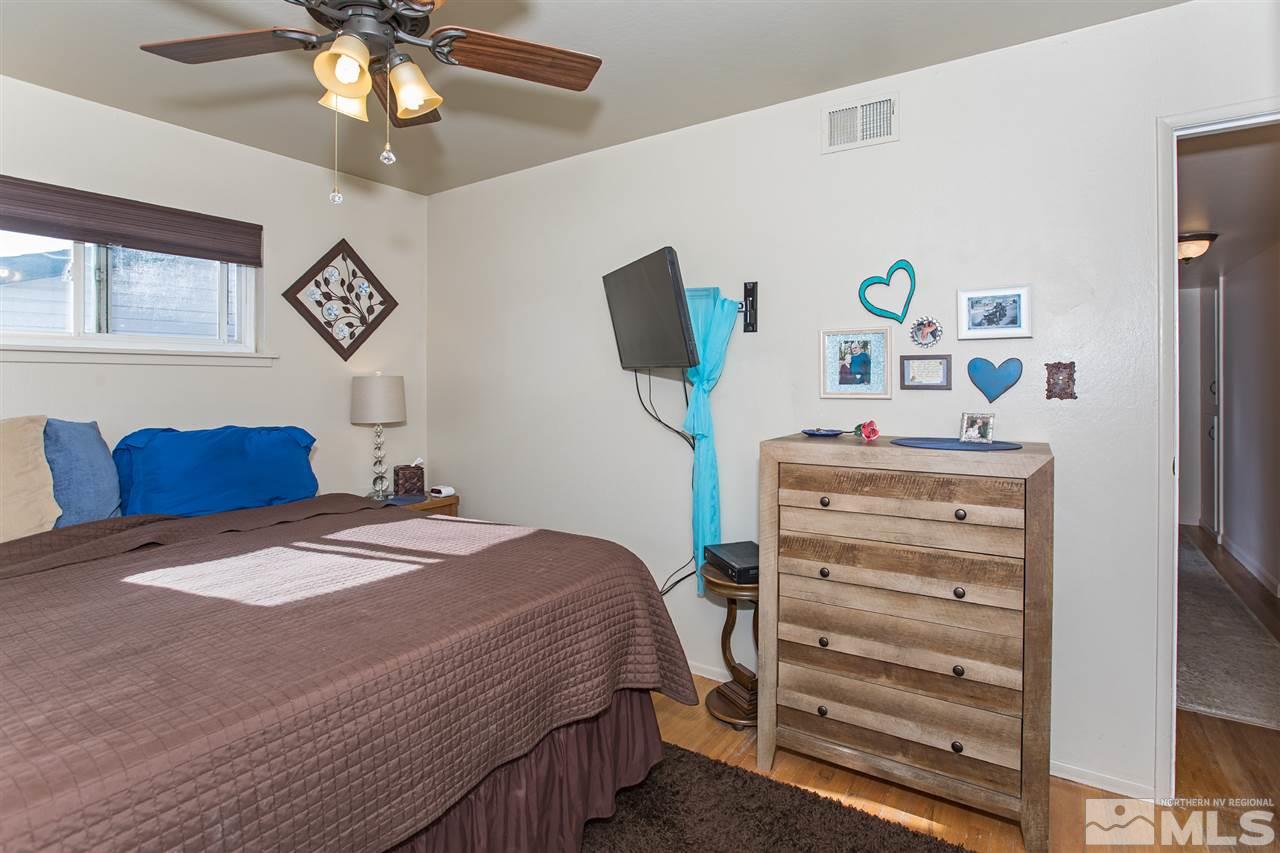 1665 Clemson Road Reno, NV 89502 - Photo 15 of 25 a bedroom with a bed and a chandelier