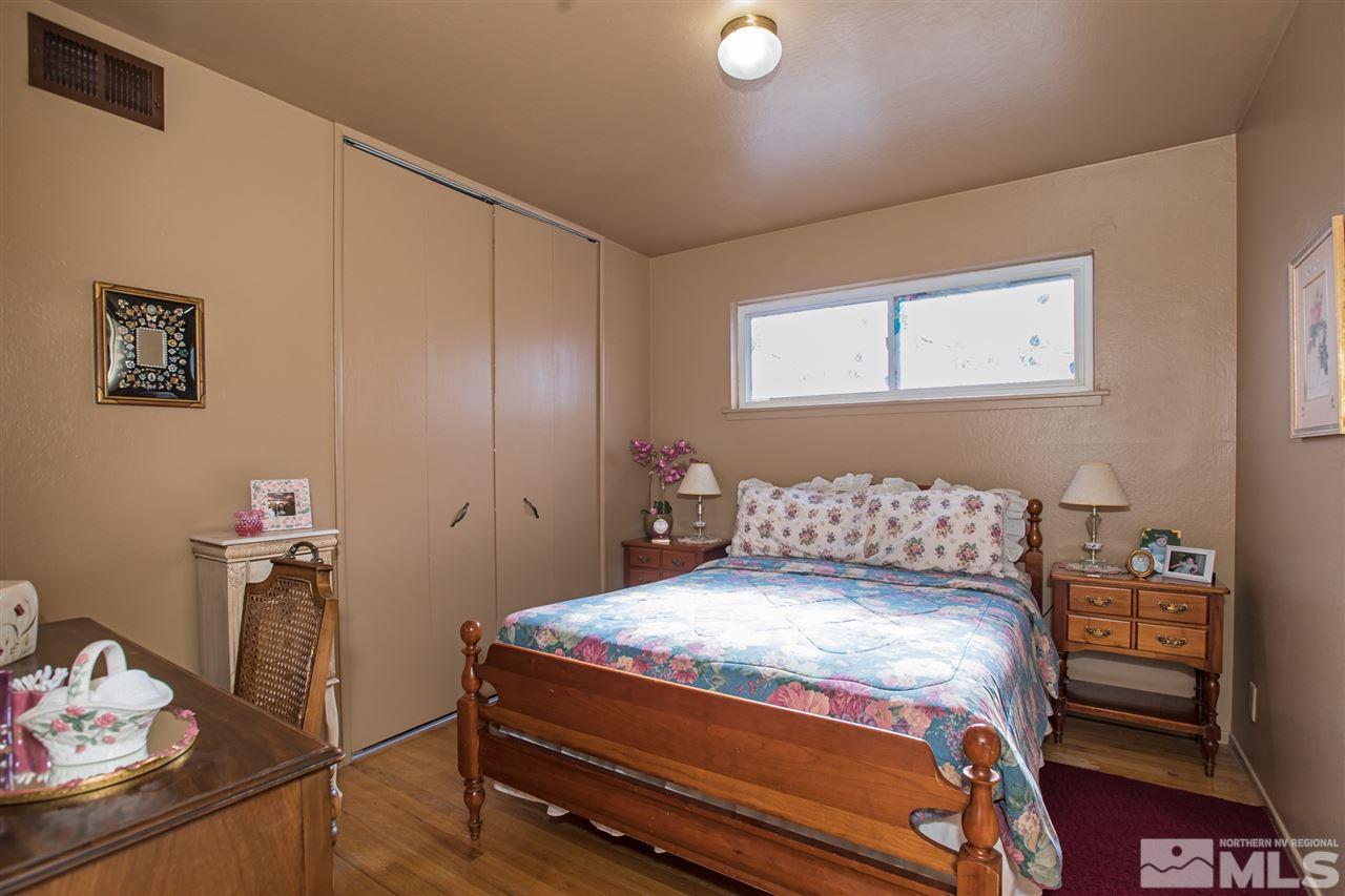 1665 Clemson Road Reno, NV 89502 - Photo 16 of 25 a bedroom with a bed and cabinets