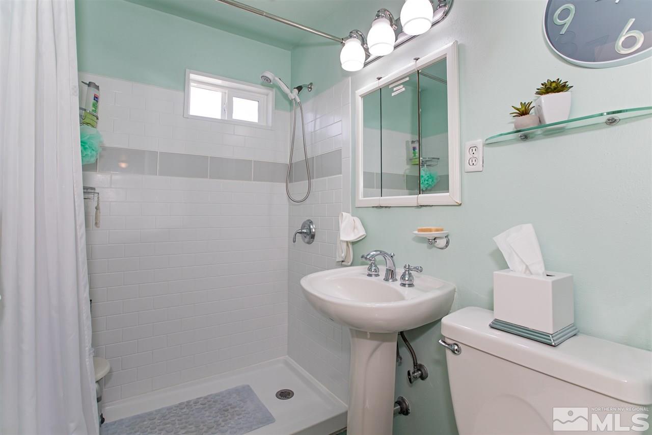 1665 Clemson Road Reno, NV 89502 - Photo 18 of 25 a bathroom with a sink a mirror and a shower