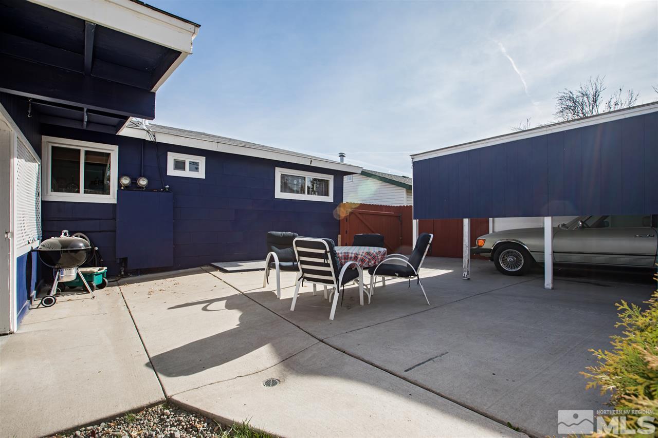 1665 Clemson Road Reno, NV 89502 - Photo 22 of 25 a view of a patio with table and chairs with wooden floor and fence