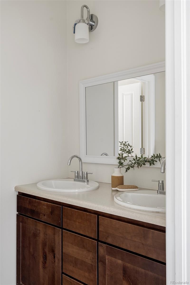 2908 Ironton Street Denver, CO 80238 - Photo 19 of 30 a bathroom with a sink and a mirror