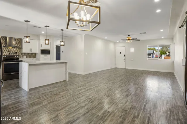 a view of kitchen with cabinets appliances and wooden floor