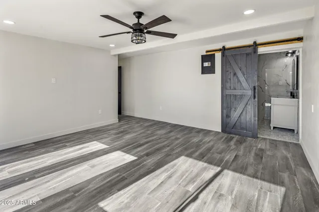 a view of empty room with a fireplace and wooden floor