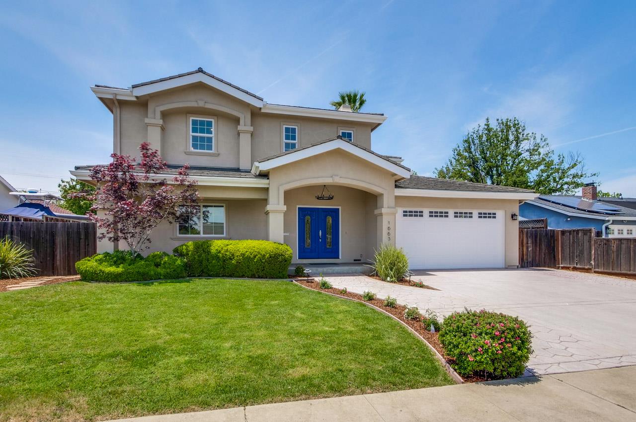 a front view of a house with garden