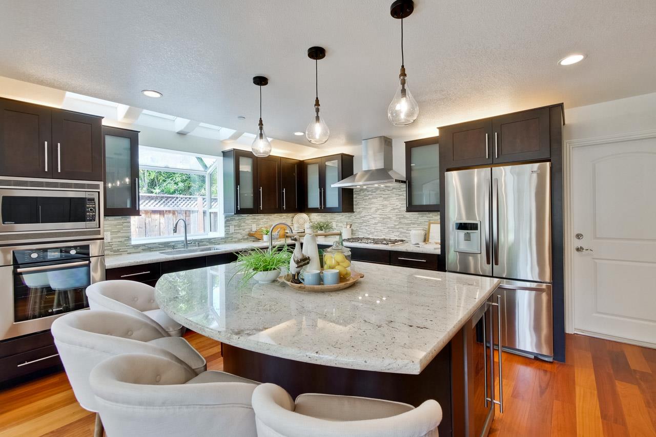 1663 Samedra Street Sunnyvale, CA 94087 - Photo 22 of 79 a kitchen with granite countertop kitchen island stainless steel appliances a refrigerator a stove a sink a dining table and chairs