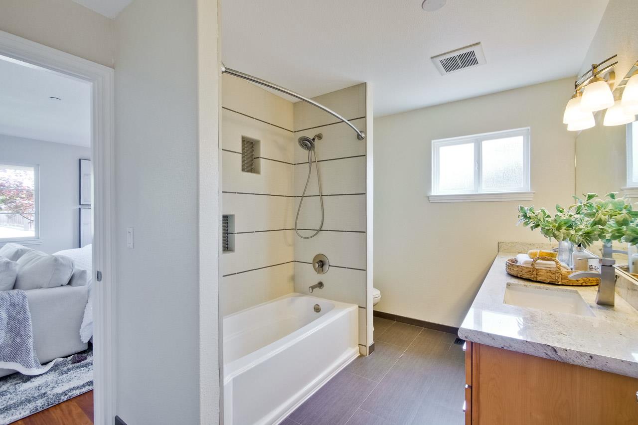1663 Samedra Street Sunnyvale, CA 94087 - Photo 34 of 79 a bathroom with a granite countertop sink a bathtub and shower