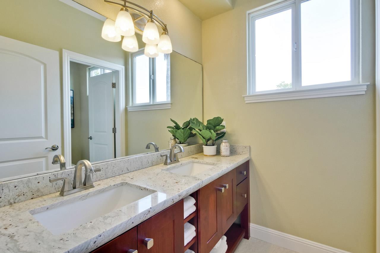 1663 Samedra Street Sunnyvale, CA 94087 - Photo 54 of 79 a bathroom with a granite countertop sink and a mirror