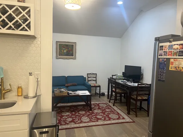 a living room with a couch and a computer on a table