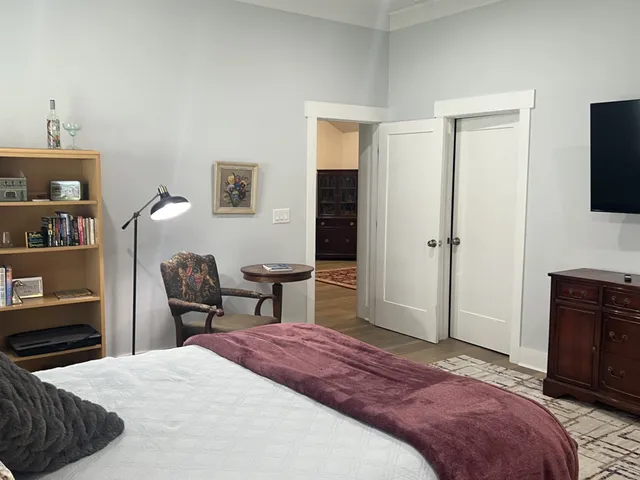 a bedroom with a bed and a flat screen tv