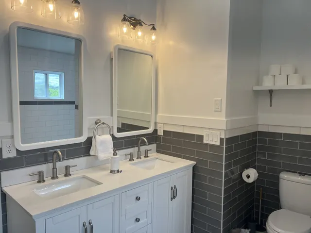 a bathroom with a sink vanity granite and toilet