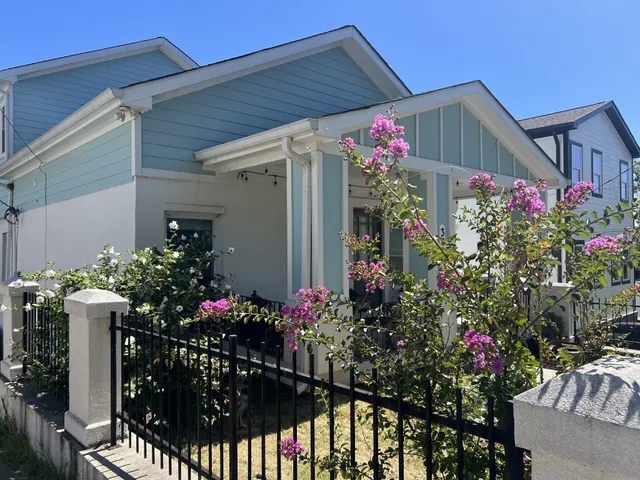 a front view of house and flowers