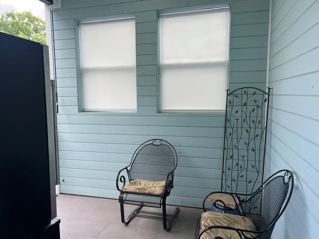 a room with a window and a chair