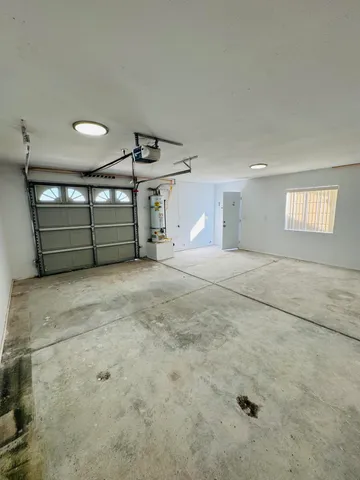 a view of a room with water heater and wooden floor