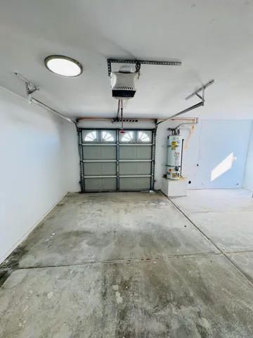 a room with water heater and racks on the wall