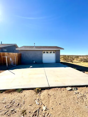 a kitchen with granite countertop a sink and white cabinets