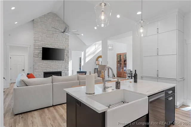 a living room with fireplace furniture and a flat screen tv