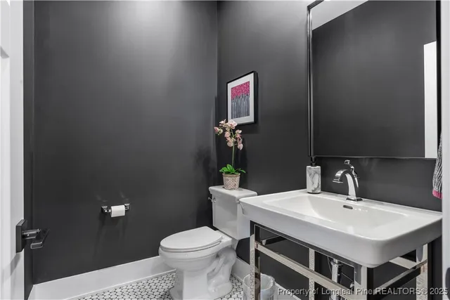 a bathroom with a sink a toilet and a mirror