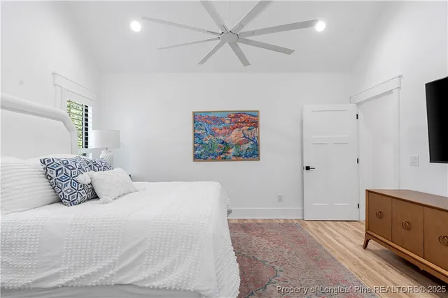 a bedroom with a bed and a painting on the wall