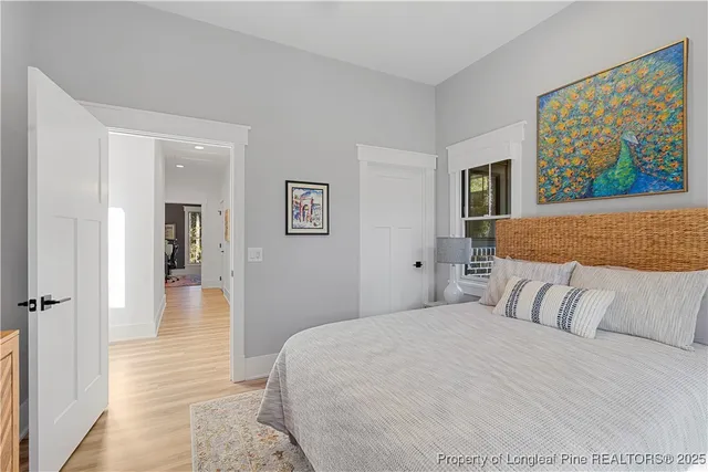 a bedroom with a bed and a painting on the wall