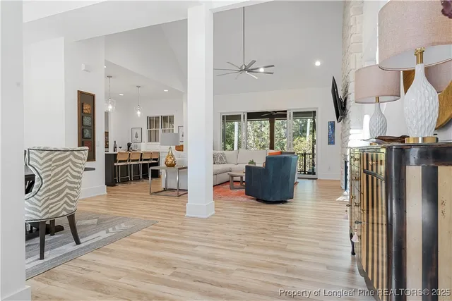 a living room with furniture a wooden floor and next to a window