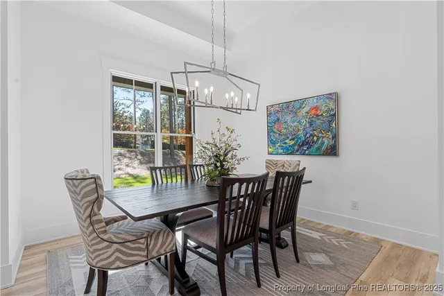 a view of a dining room with furniture wooden floor and chandelier