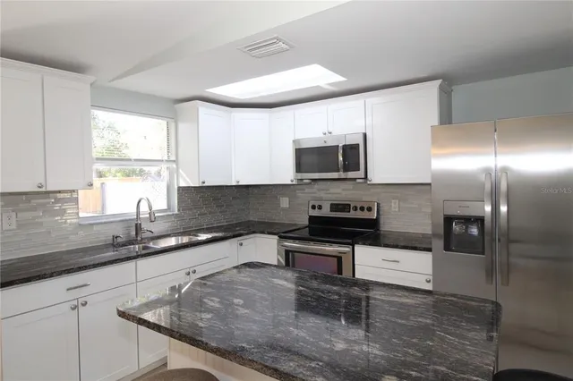 a view of house with a yard